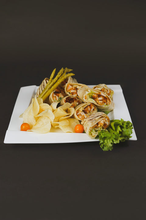 Grilled Chicken Caesar Wraps with Romaine lettuce, Parmesan cheese, and Caesar dressing