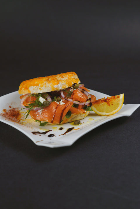 Smoked Salmon and Cream Cheese Bagels with thinly sliced red onion, capers, and lemon wedges