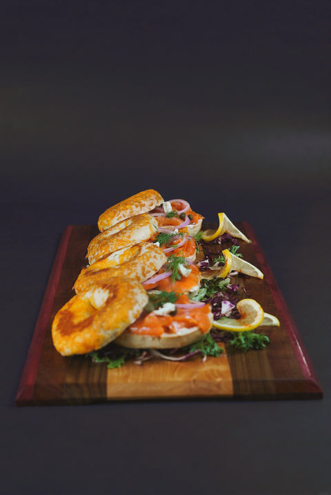 Smoked Salmon and Cream Cheese Bagels with thinly sliced red onion, capers, and lemon wedges