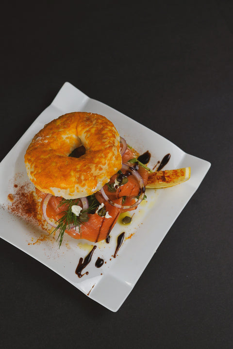 Smoked Salmon and Cream Cheese Bagels with thinly sliced red onion, capers, and lemon wedges